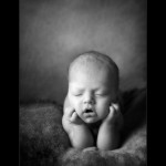 Baby photography glasgow newborn baby with head in hands