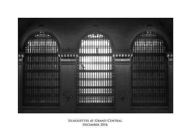 Silhouettes walking past the windows at Grand Central station New York