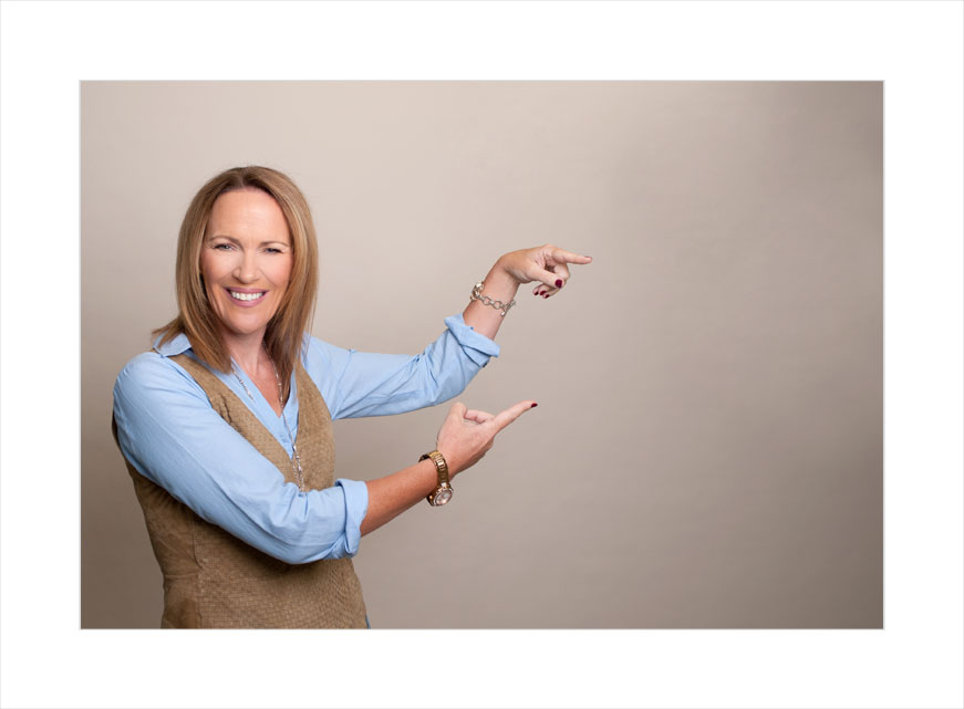 headshot, personal branding, pointing to the side with both hands, woman in waistcoat, time management, what does your headshot say aabout you