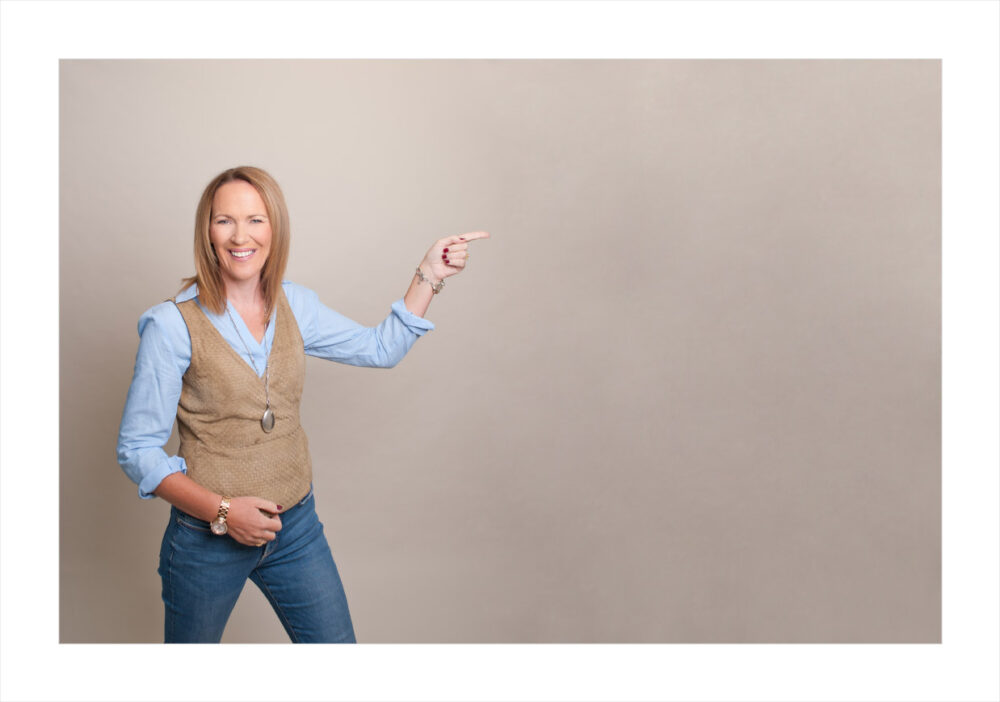 headshot, personal branding, pointing tp the side, woman in waistcoat, time management, what does your headshot say aabout you